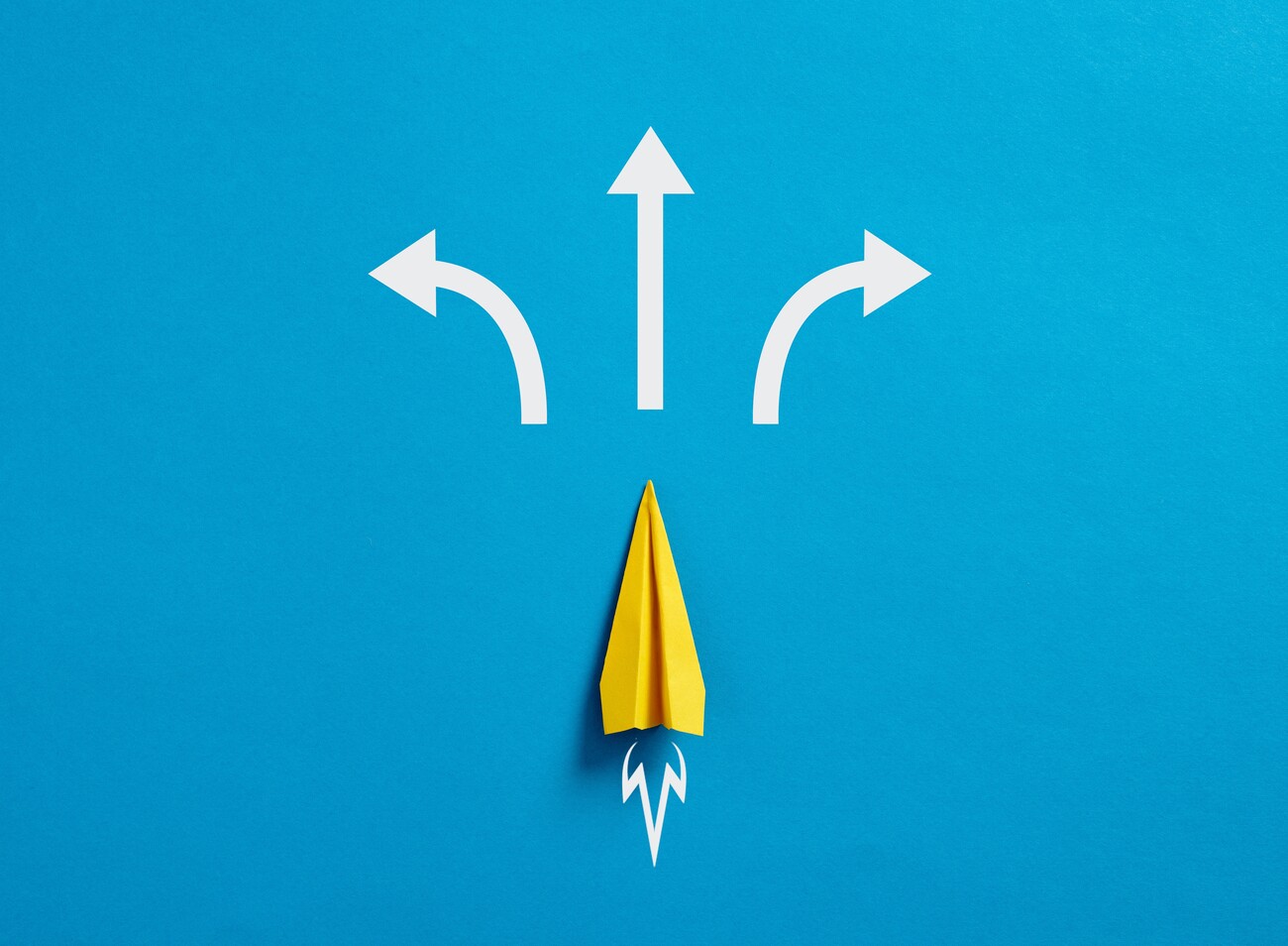 Business decision making and the way to success. Choosing a strategic path to move forward. Alternative options and business solutions. Paper plane with arrows pointing different directions.; Shutterstock ID 2255670075